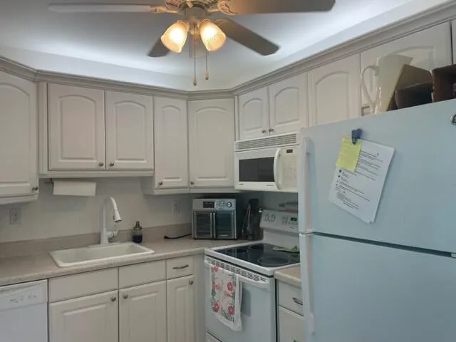a kitchen with stainless steel appliances white cabinets and a sink