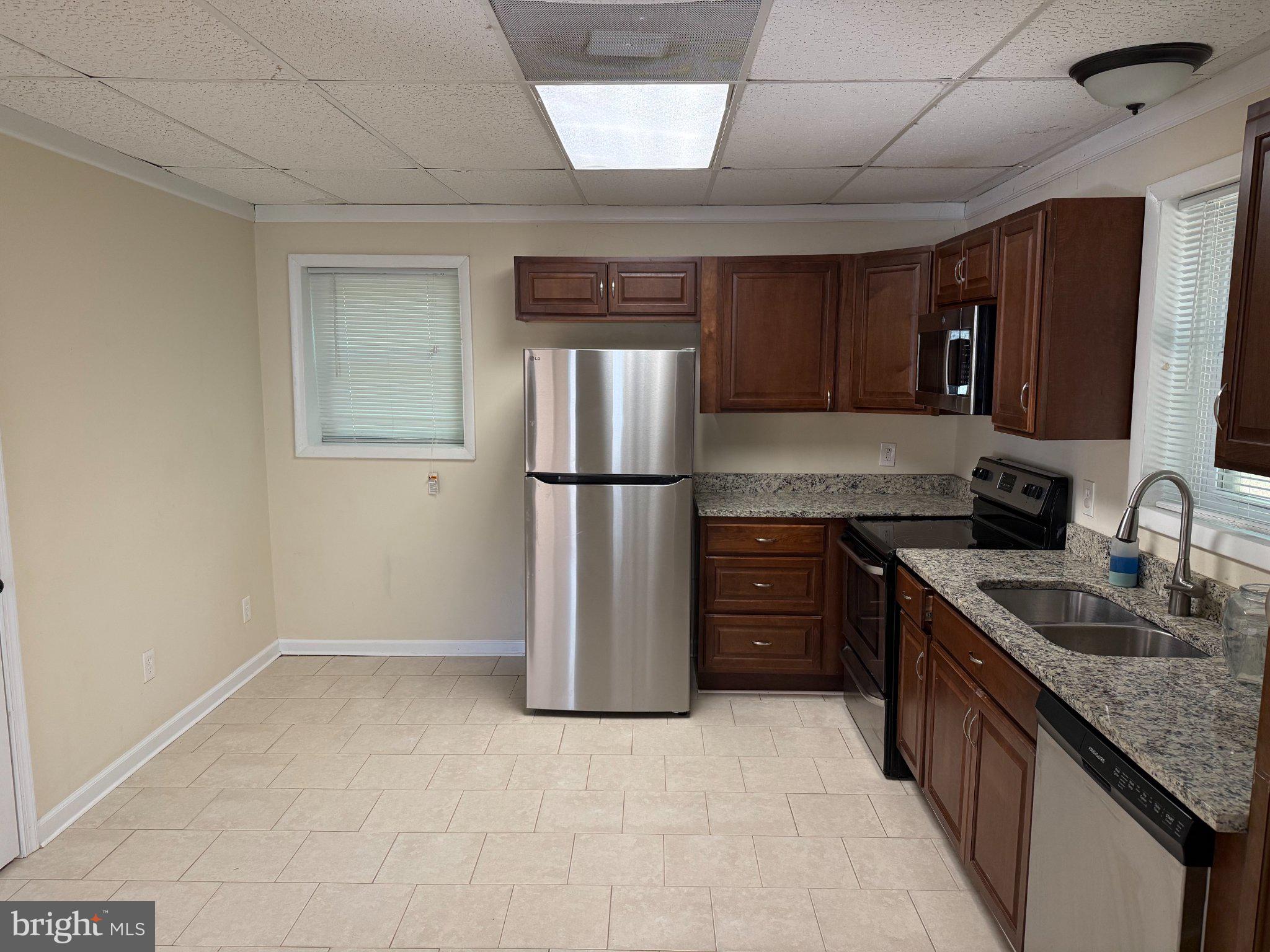 2446 Mountain View Road Stafford, VA 22556 - Photo 2 of 11 a kitchen with a refrigerator sink and stove