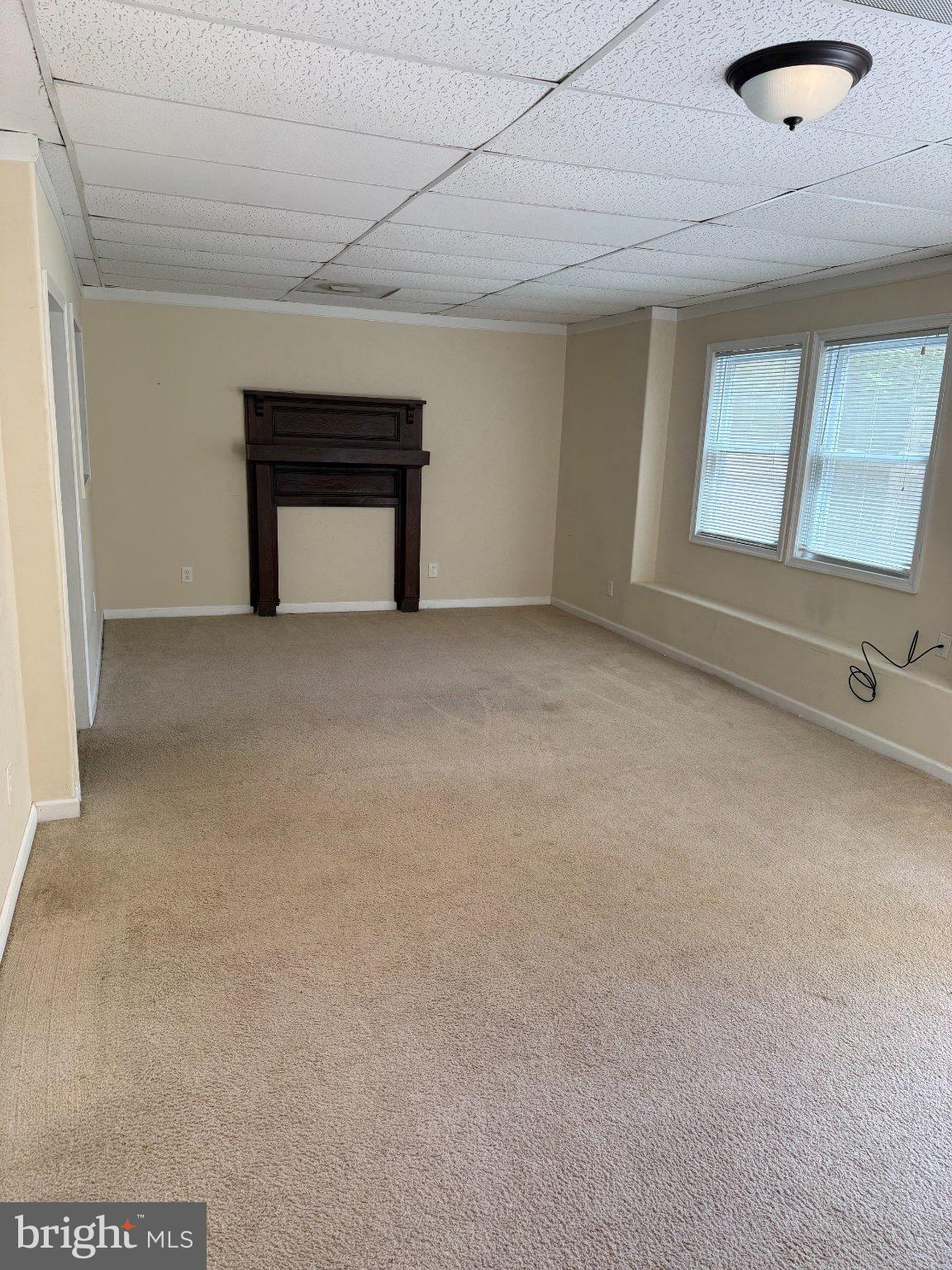 2446 Mountain View Road Stafford, VA 22556 - Photo 5 of 11 a view of an empty room with a fireplace and a window