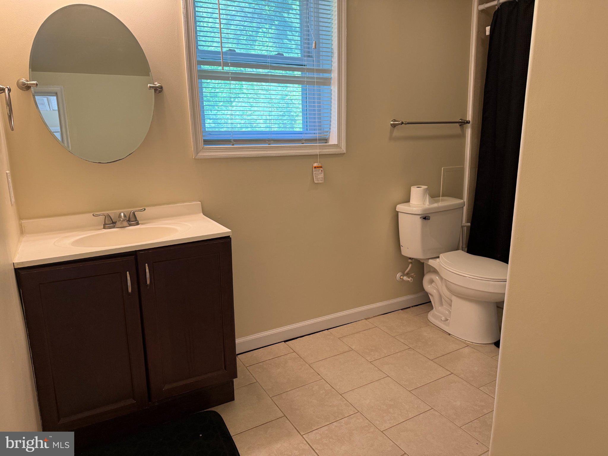 2446 Mountain View Road Stafford, VA 22556 - Photo 7 of 11 a bathroom with a sink a toilet and a mirror