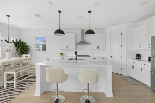 a front view of a house with a garden and yard