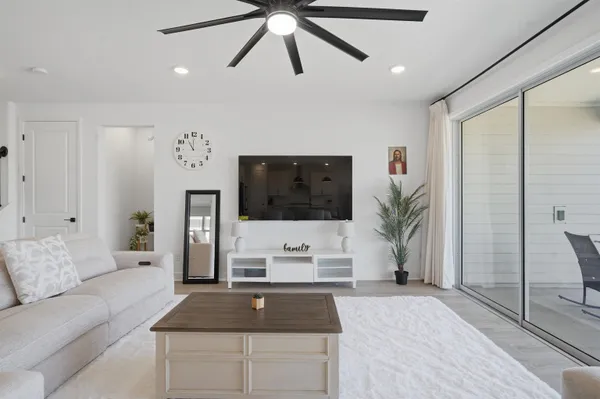 a kitchen with stainless steel appliances a sink a stove and a wooden floor