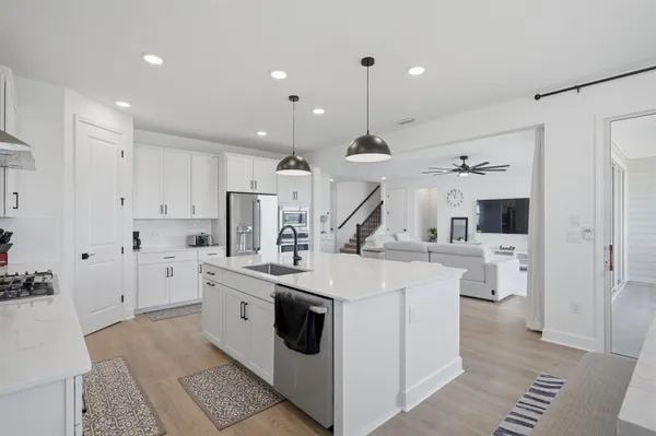 a view of a dining room with furniture wooden floor and a chandelier