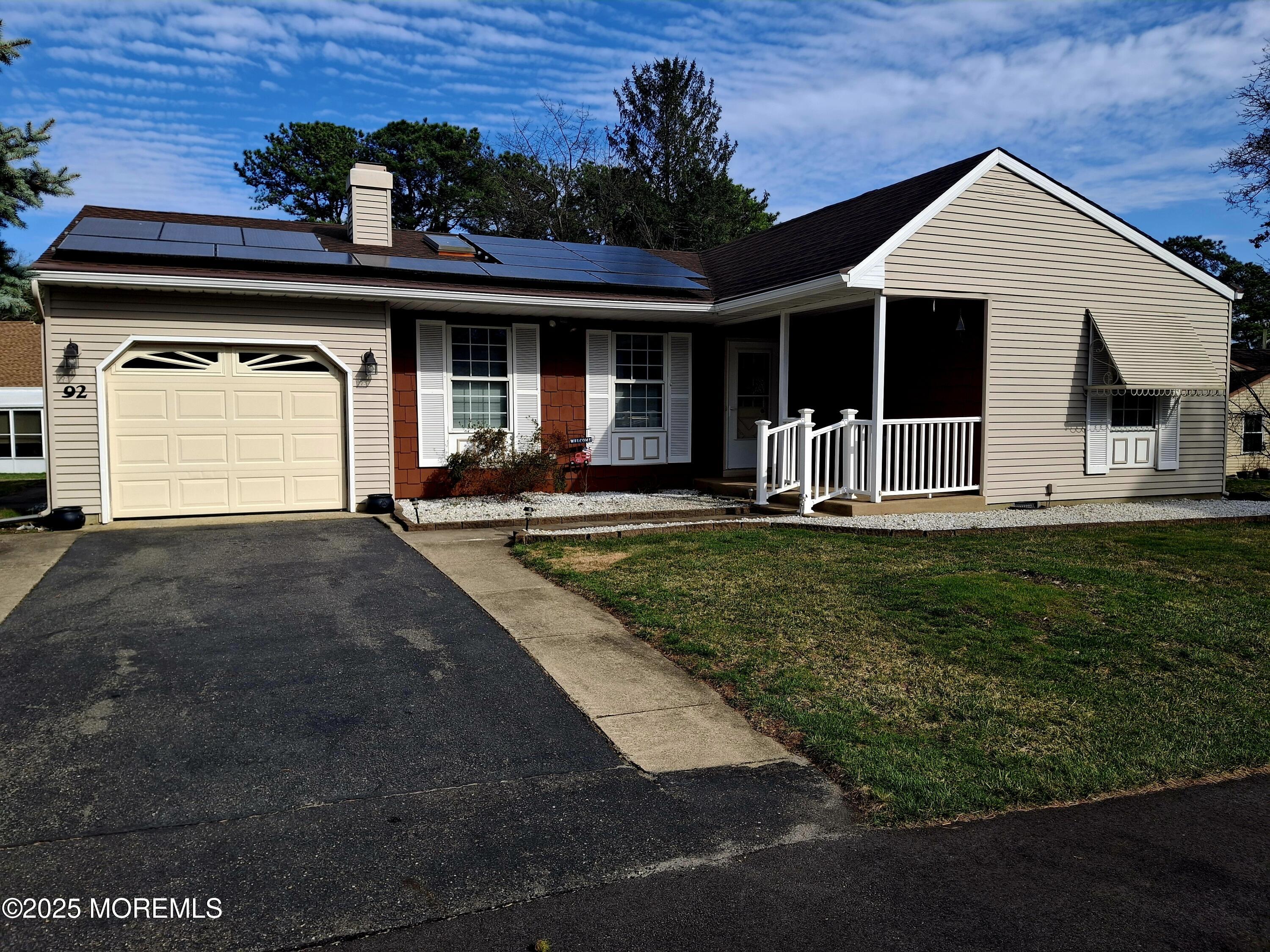 92 Sunset Road, Unit 60 Whiting, NJ 08759 - Photo 1 of 25 a front view of a house with a yard