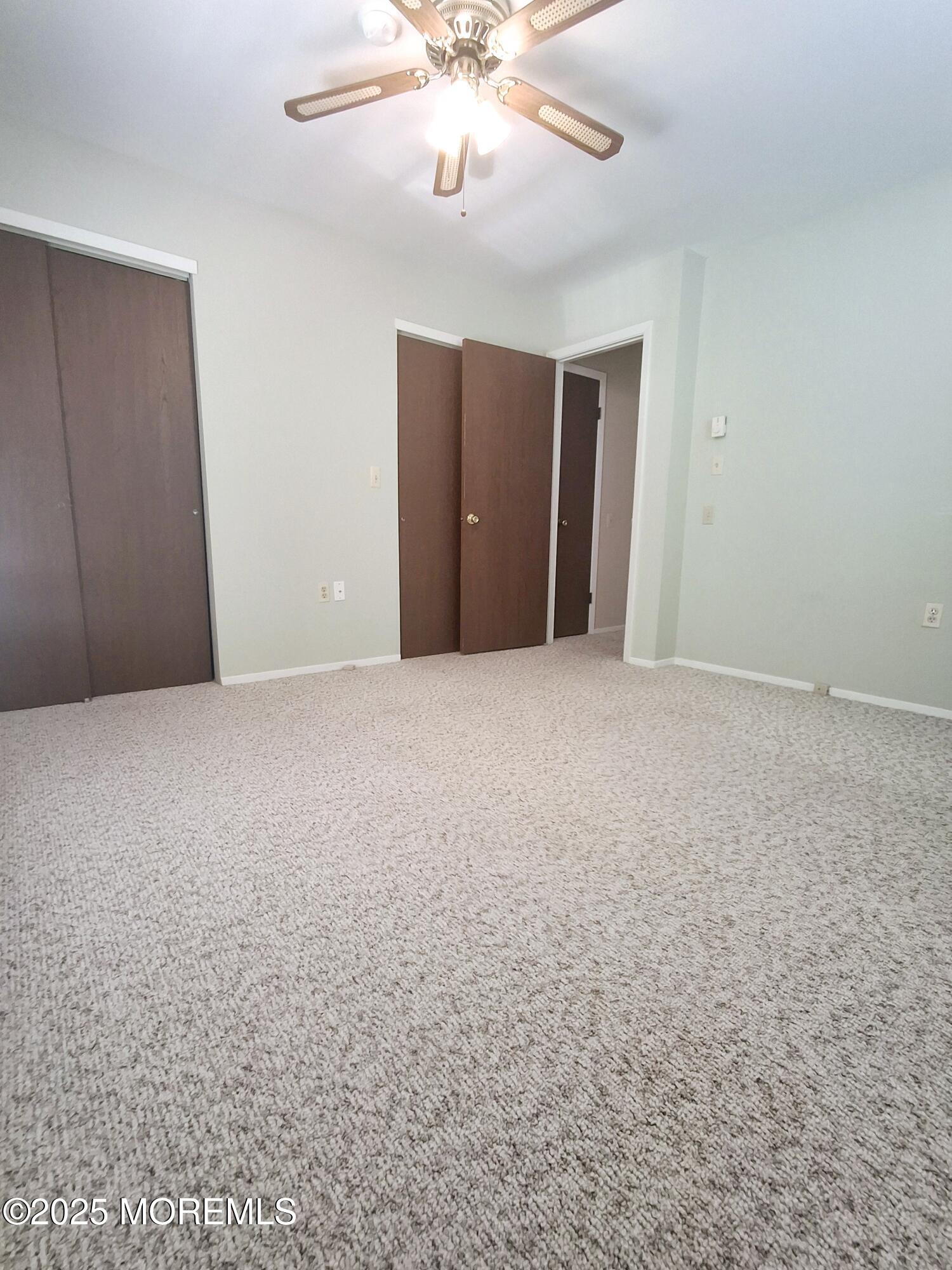 92 Sunset Road, Unit 60 Whiting, NJ 08759 - Photo 17 of 25 a view of an empty room with chandelier fan