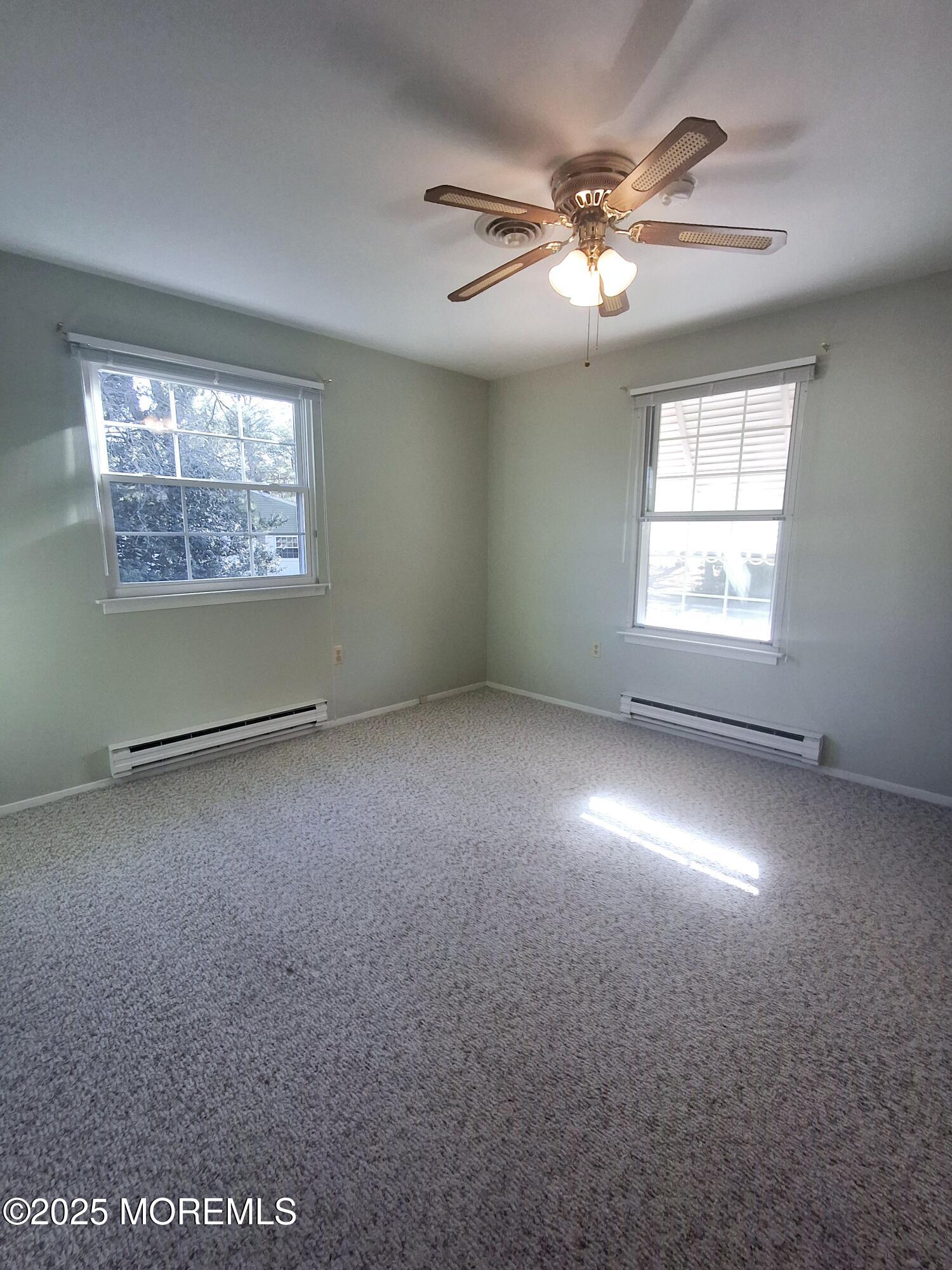 92 Sunset Road, Unit 60 Whiting, NJ 08759 - Photo 18 of 25 an empty room with a window and a ceiling fan