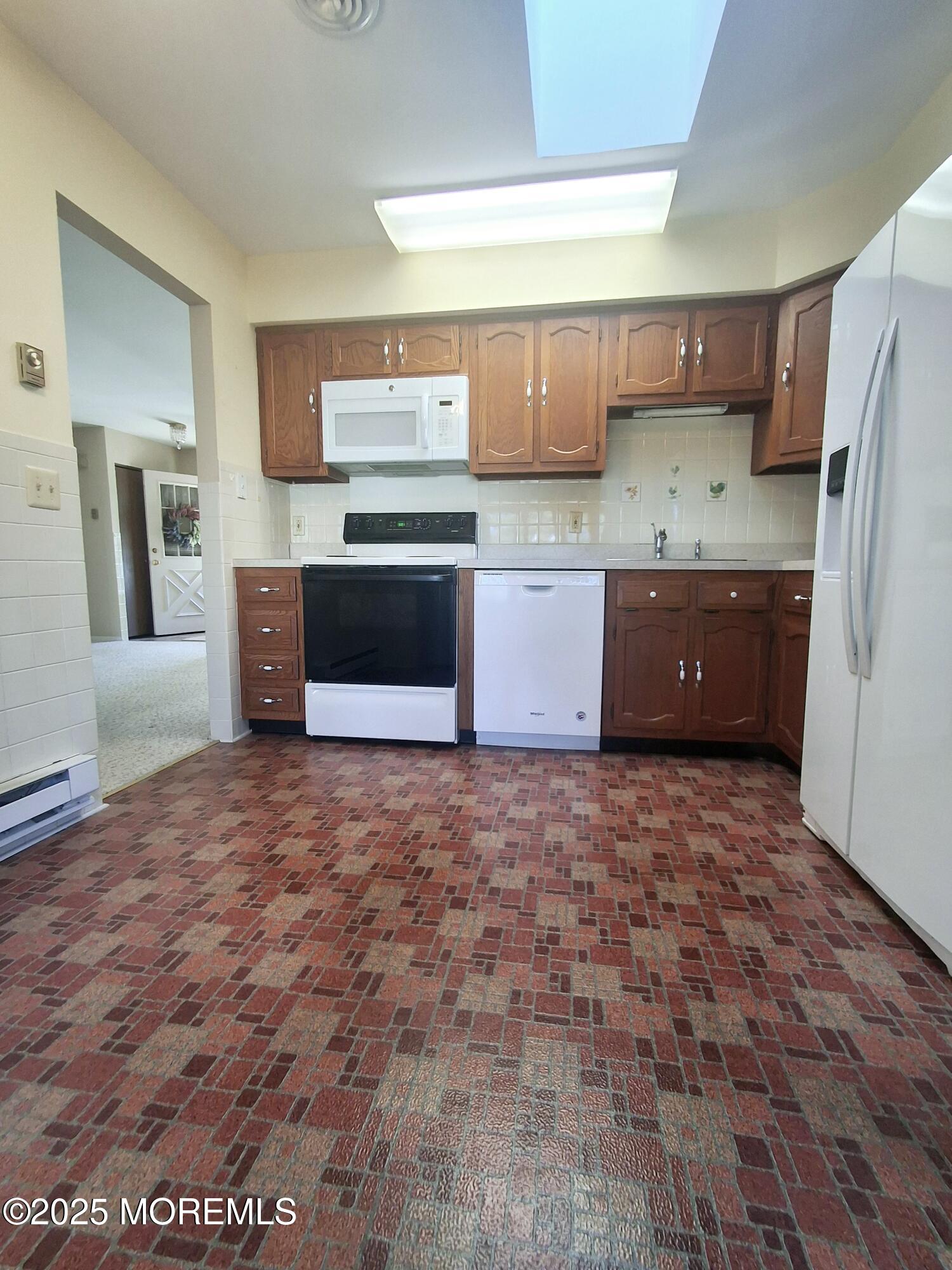 92 Sunset Road, Unit 60 Whiting, NJ 08759 - Photo 20 of 25 a kitchen with stainless steel appliances a refrigerator and a stove