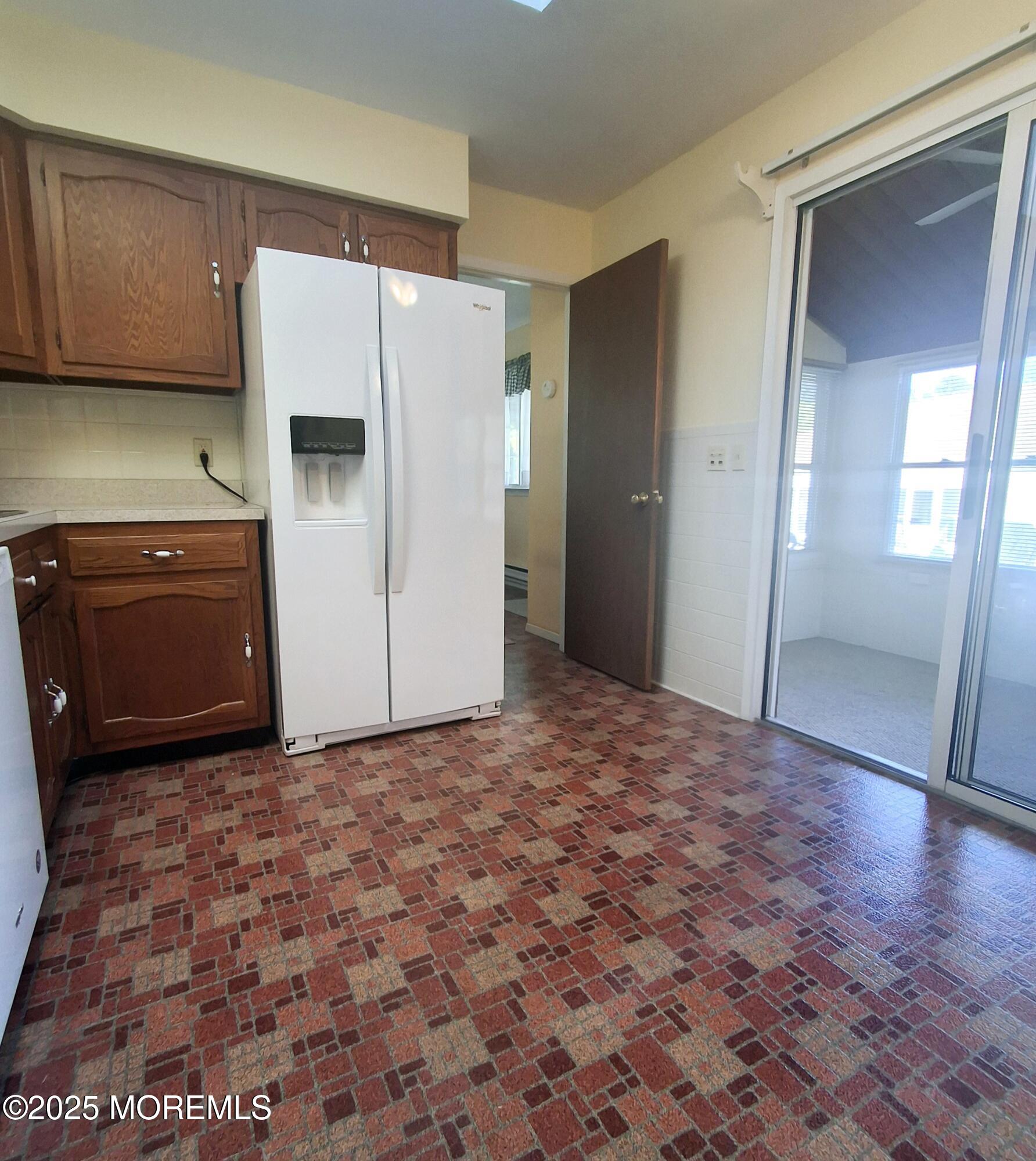 92 Sunset Road, Unit 60 Whiting, NJ 08759 - Photo 22 of 25 a view of a kitchen with refrigerator and cabinet
