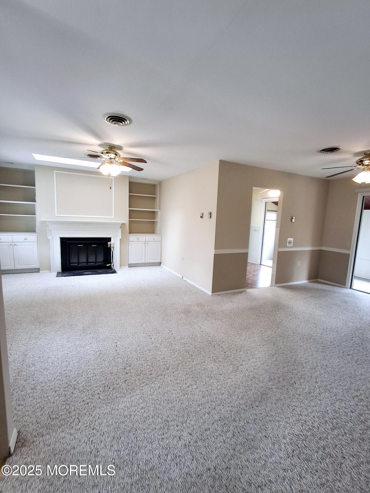 92 Sunset Road, Unit 60 Whiting, NJ 08759 - Photo 5 of 25 a view of empty room with a fireplace