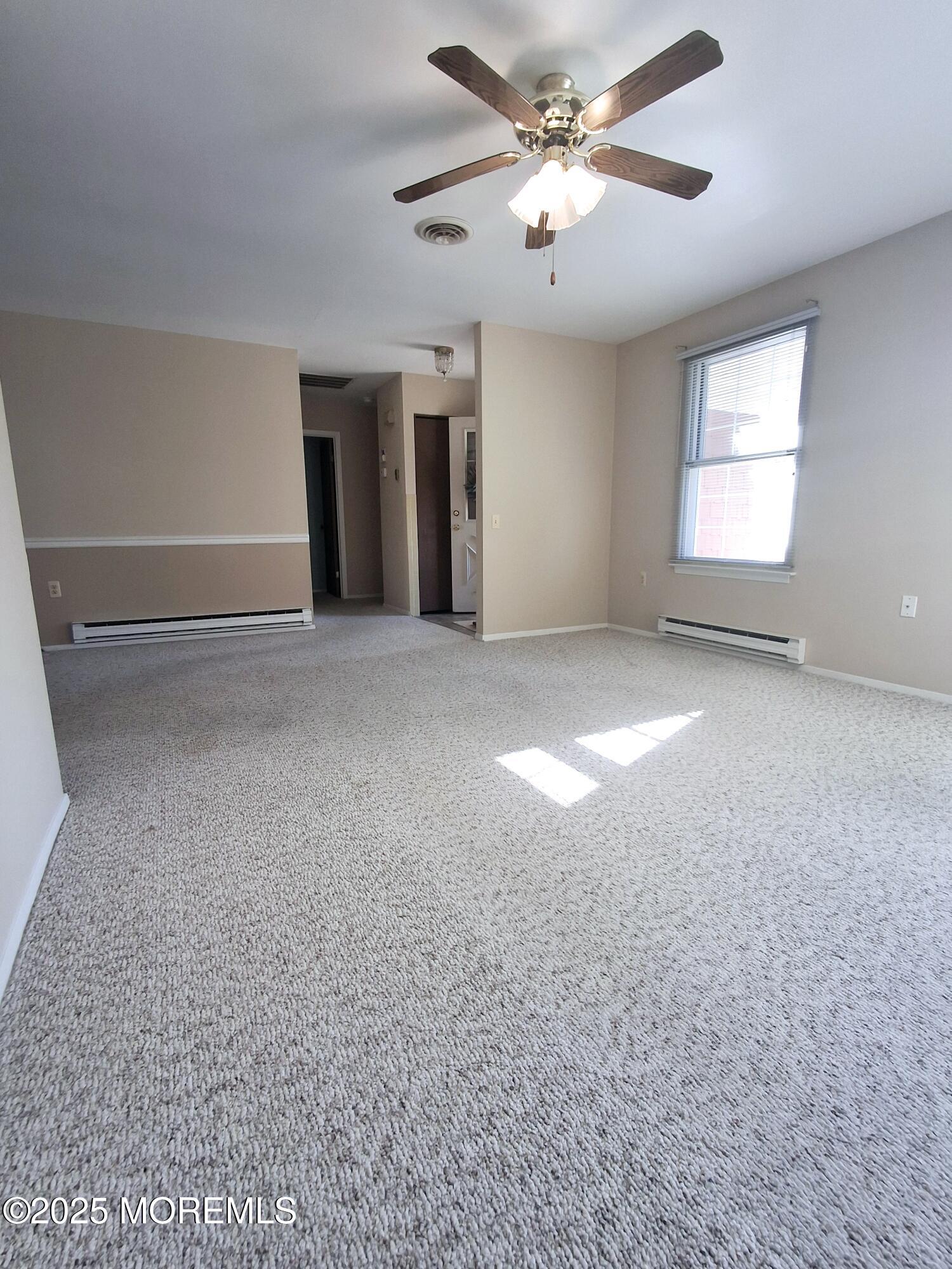 92 Sunset Road, Unit 60 Whiting, NJ 08759 - Photo 10 of 25 a view of a livingroom with a ceiling fan and window