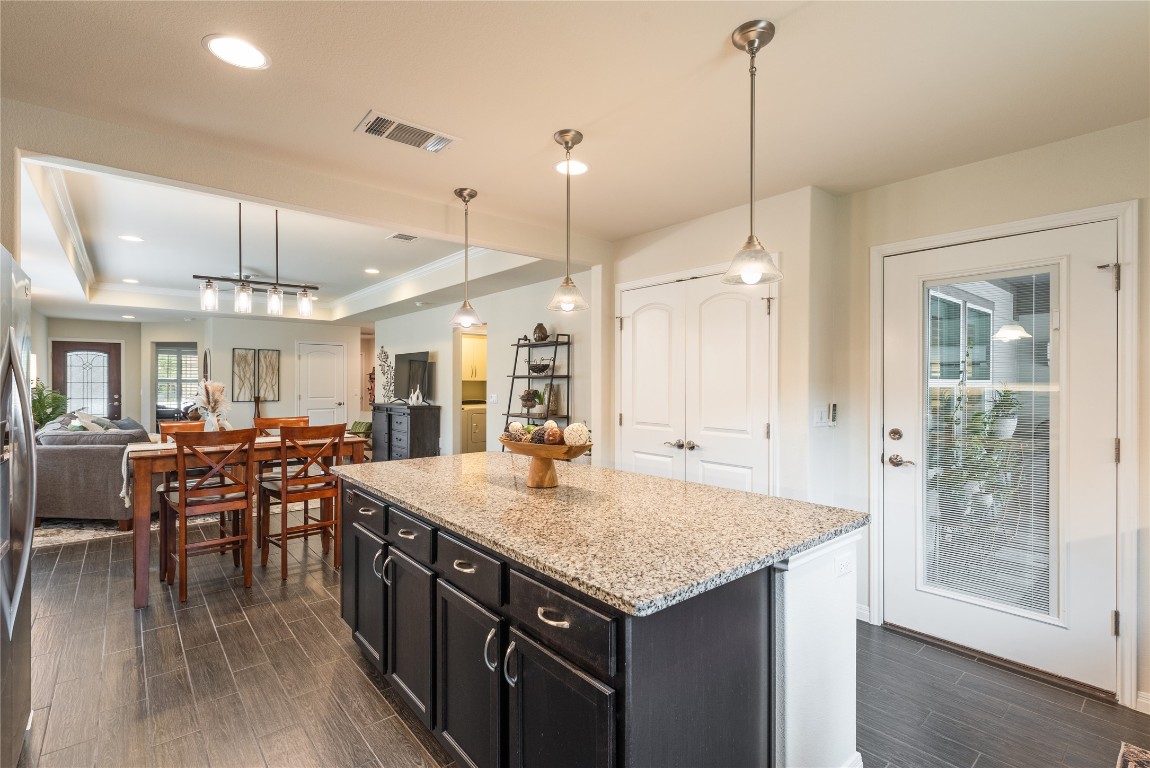 307 Hobby Street Georgetown, TX 78633 - Photo 16 of 40 a kitchen with center island table and chairs