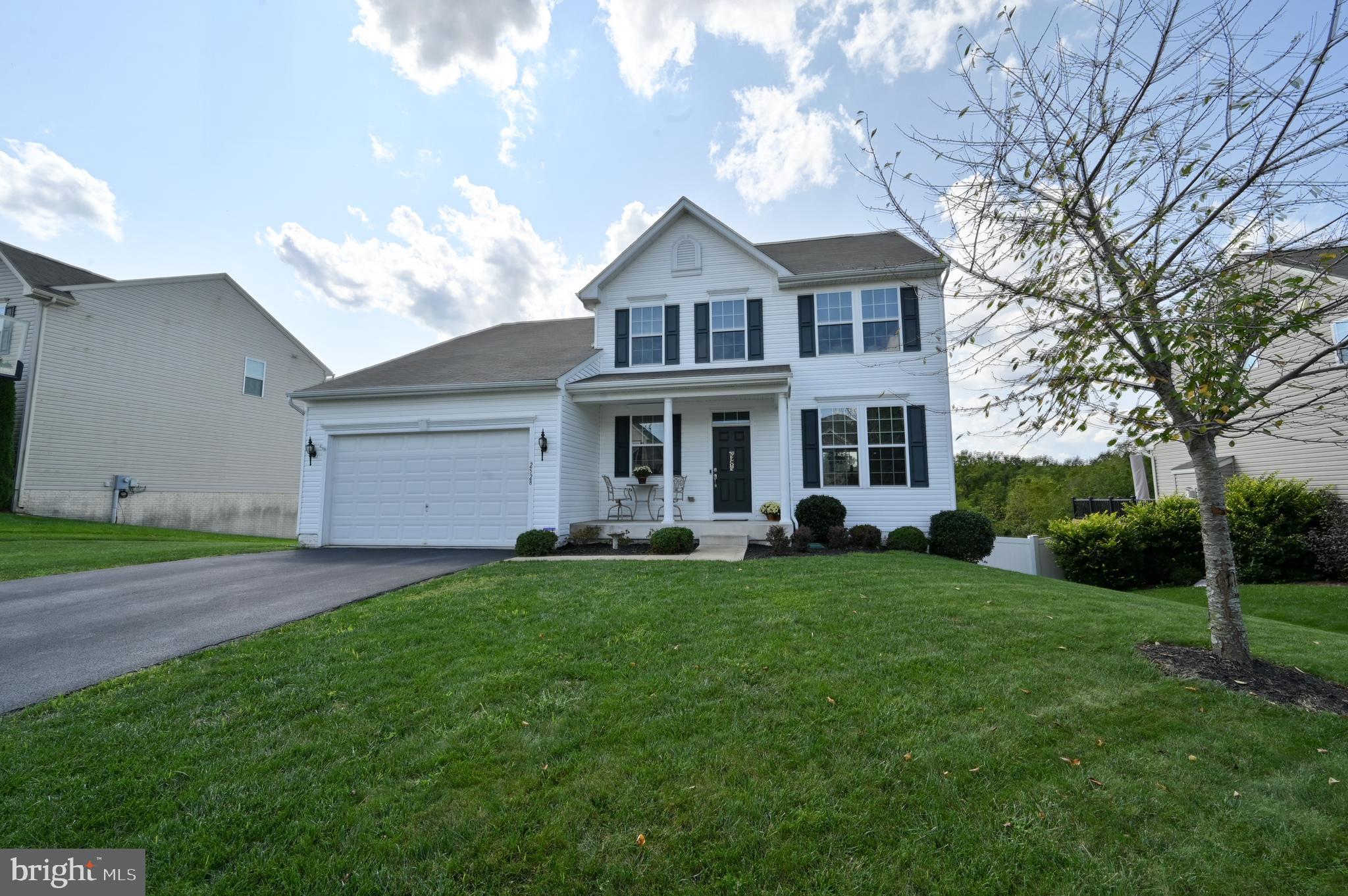 2528 Codorus Lane Spring Grove, PA 17362 - Photo 1 of 77 a front view of a house with a garden and trees