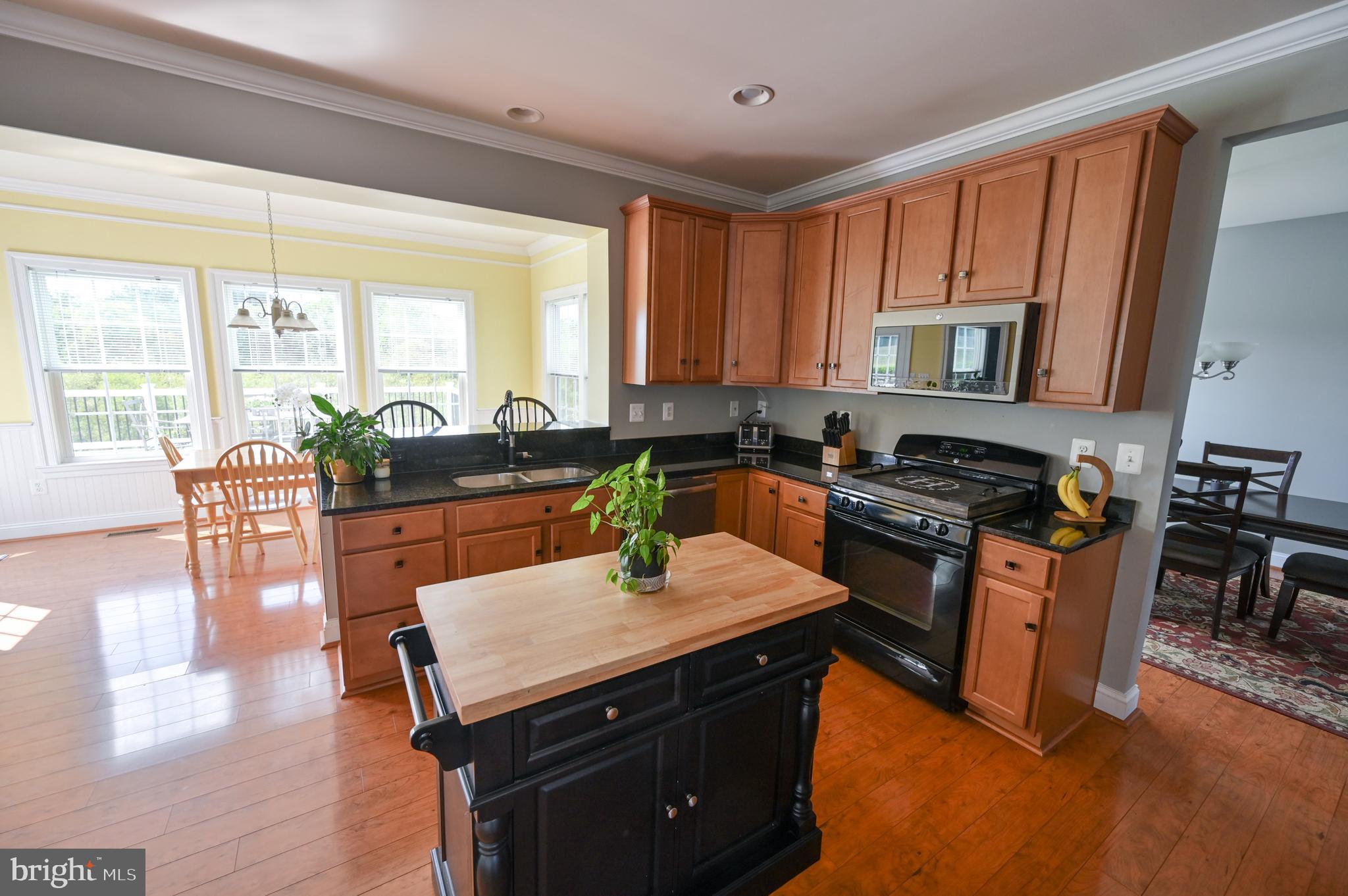 2528 Codorus Lane Spring Grove, PA 17362 - Photo 22 of 77 a kitchen with a stove top oven a sink a dining table and chairs