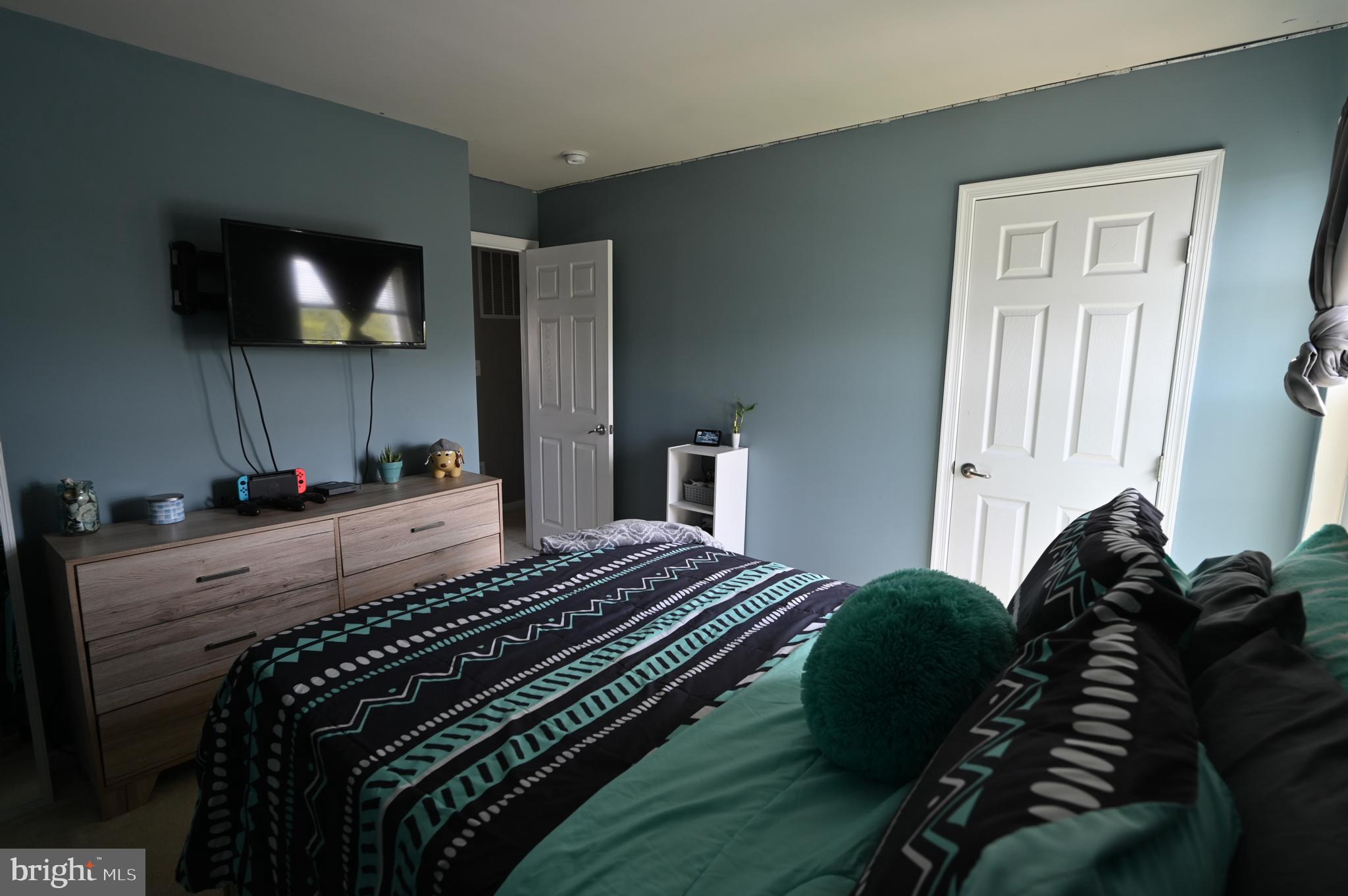 2528 Codorus Lane Spring Grove, PA 17362 - Photo 59 of 77 a bedroom with a bed next to a window with flat screen tv