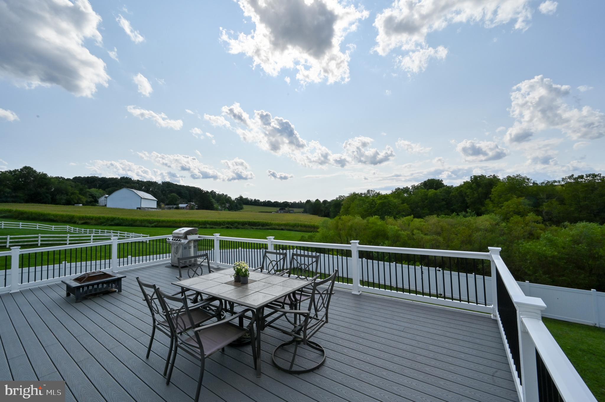 2528 Codorus Lane Spring Grove, PA 17362 - Photo 68 of 77 a view of a roof deck with table and chairs a barbeque with wooden floor and fence