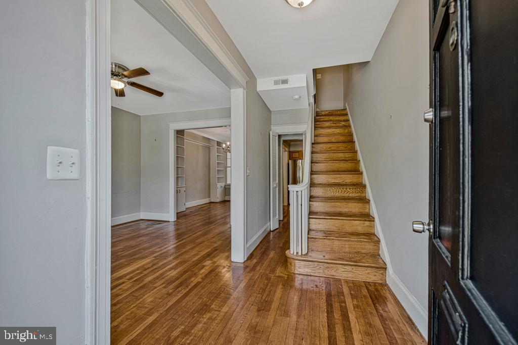 2406 37th Street Northwest Washington, DC 20007 - Photo 25 of 44 a view of a hallway with wooden floor and staircase