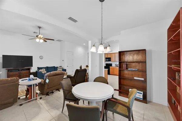a living room with furniture a flat screen tv and a window