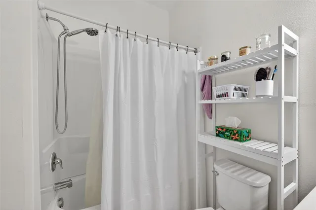 a bedroom with a bed and a dresser next to a window