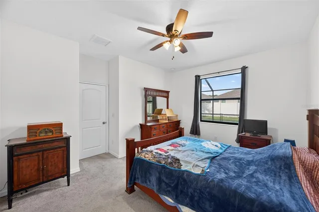 a bedroom with a bed and a desk