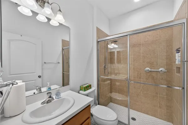 a bathroom with a sink a toilet and shower