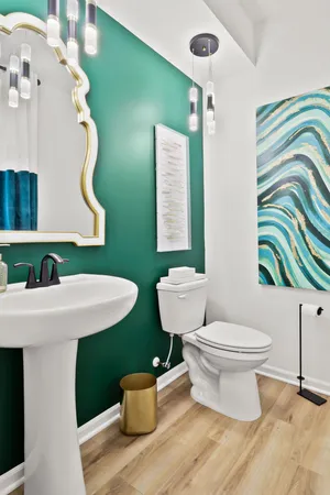 a bathroom with a toilet sink and mirror