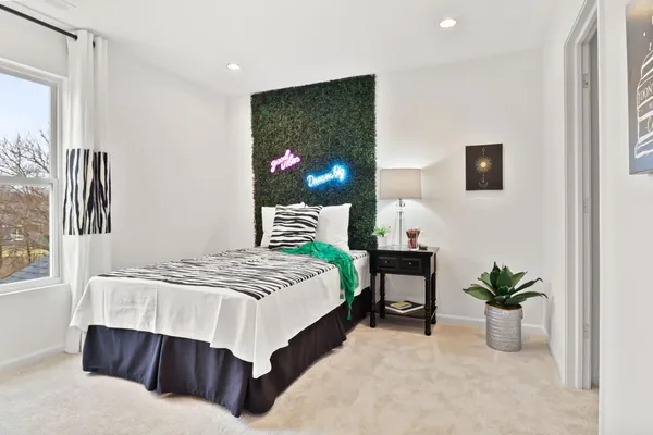 a bedroom with a bed and a potted plant