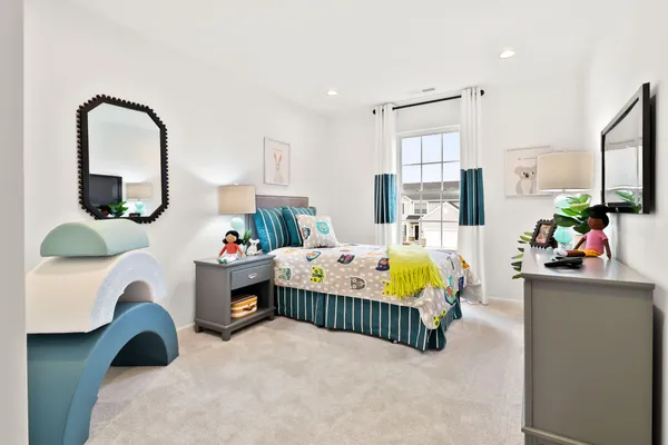 a bedroom with furniture and a mirror