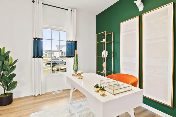 a living room with stainless steel appliances furniture a rug and a window