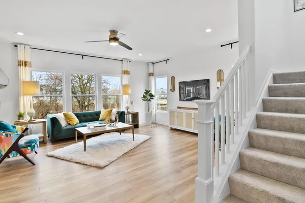 a living room with furniture wooden floor and a flat screen tv