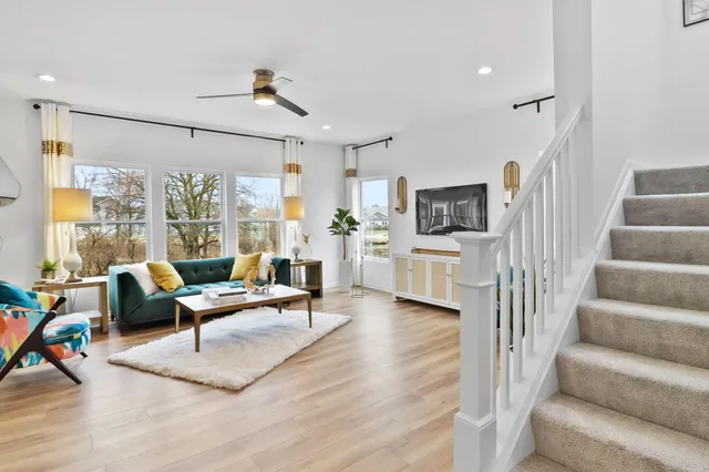 a living room with furniture wooden floor and a flat screen tv