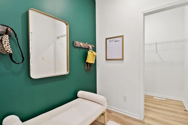 a bathroom with a toilet and a mirror