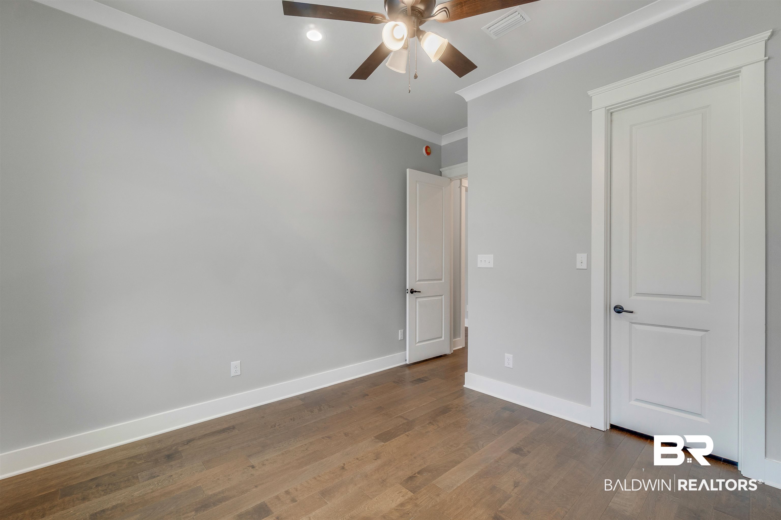 10985 Atrium Avenue Fairhope, AL 36532 - Photo 39 of 58 Unfurnished bedroom with crown molding, wood finished floors, and ceiling fan