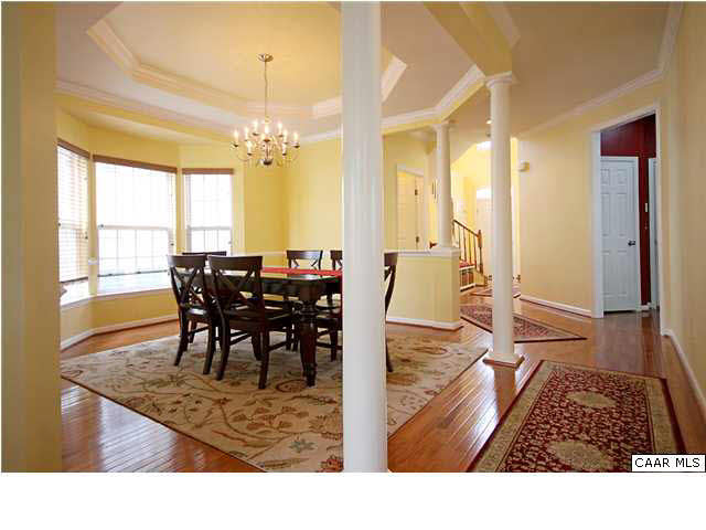 708 Rainier Road Charlottesville, VA 22903 - Photo 11 of 29 a view of a dining room and livingroom with furniture wooden floor a chandelier