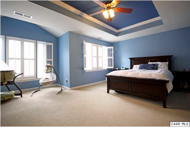 708 Rainier Road Charlottesville, VA 22903 - Photo 14 of 29 a living room with a bed furniture and a chandelier