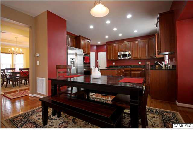 708 Rainier Road Charlottesville, VA 22903 - Photo 6 of 29 a open kitchen with stainless steel appliances kitchen island granite countertop a refrigerator a stove and a sink with wooden floor