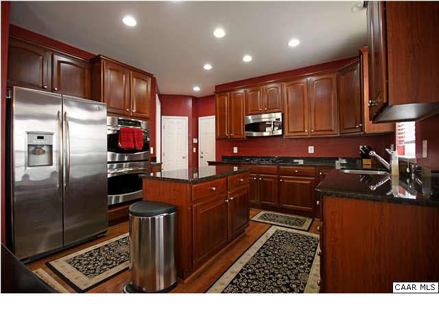 708 Rainier Road Charlottesville, VA 22903 - Photo 8 of 29 a kitchen with stainless steel appliances kitchen island granite countertop a refrigerator and a sink