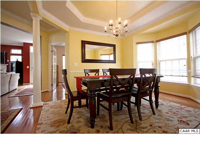 708 Rainier Road Charlottesville, VA 22903 - Photo 10 of 29 a dining room with furniture a chandelier and wooden floor
