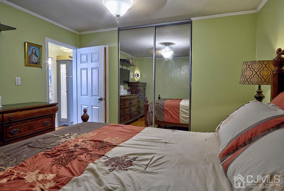 10 Pennington Road New Brunswick, NJ 08901 - Photo 11 of 29 a bedroom with a bed and a dresser