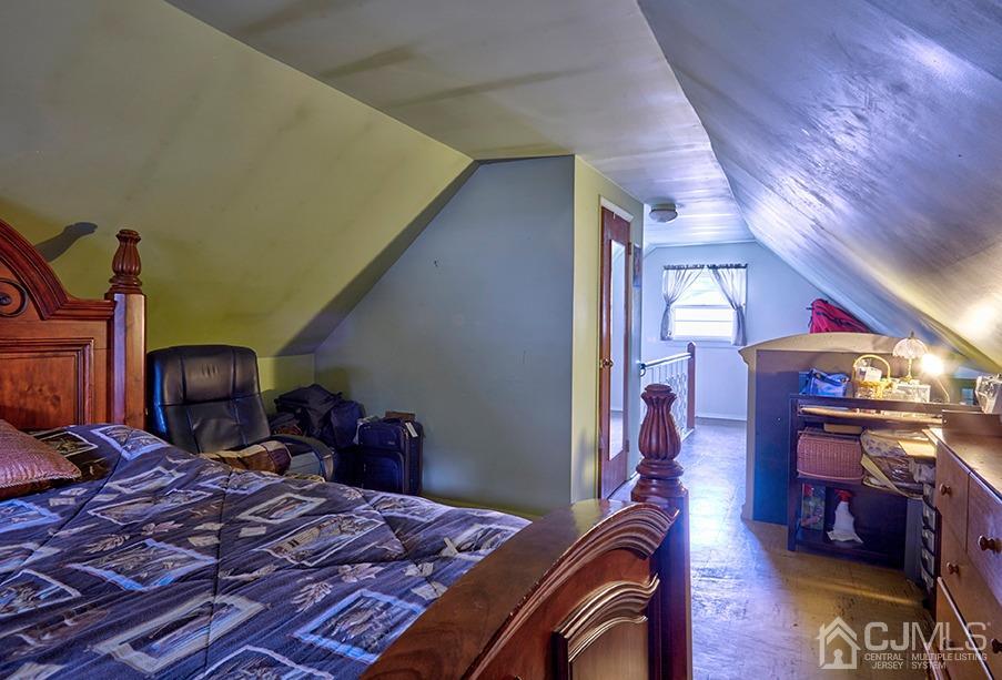 10 Pennington Road New Brunswick, NJ 08901 - Photo 15 of 29 a bedroom with a bed and wooden floor