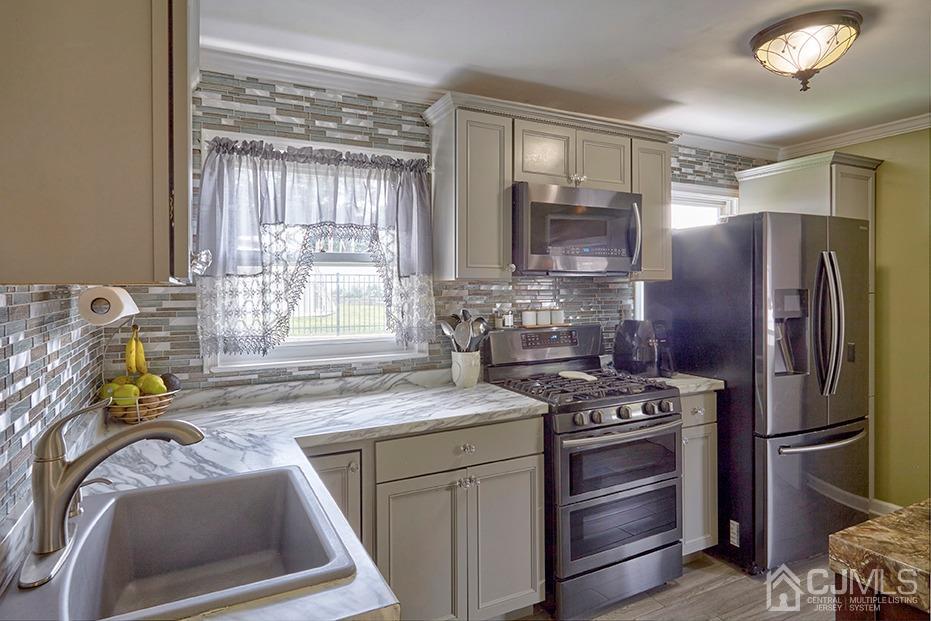 10 Pennington Road New Brunswick, NJ 08901 - Photo 7 of 29 a kitchen with stainless steel appliances granite countertop a sink stove and refrigerator