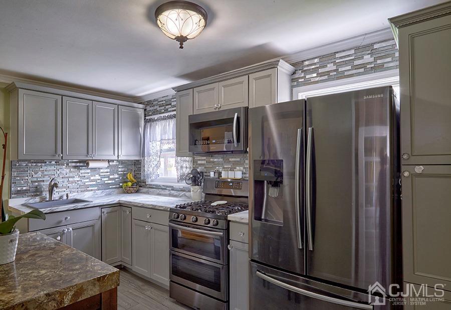 10 Pennington Road New Brunswick, NJ 08901 - Photo 8 of 29 a kitchen with stainless steel appliances granite countertop a refrigerator stove and sink
