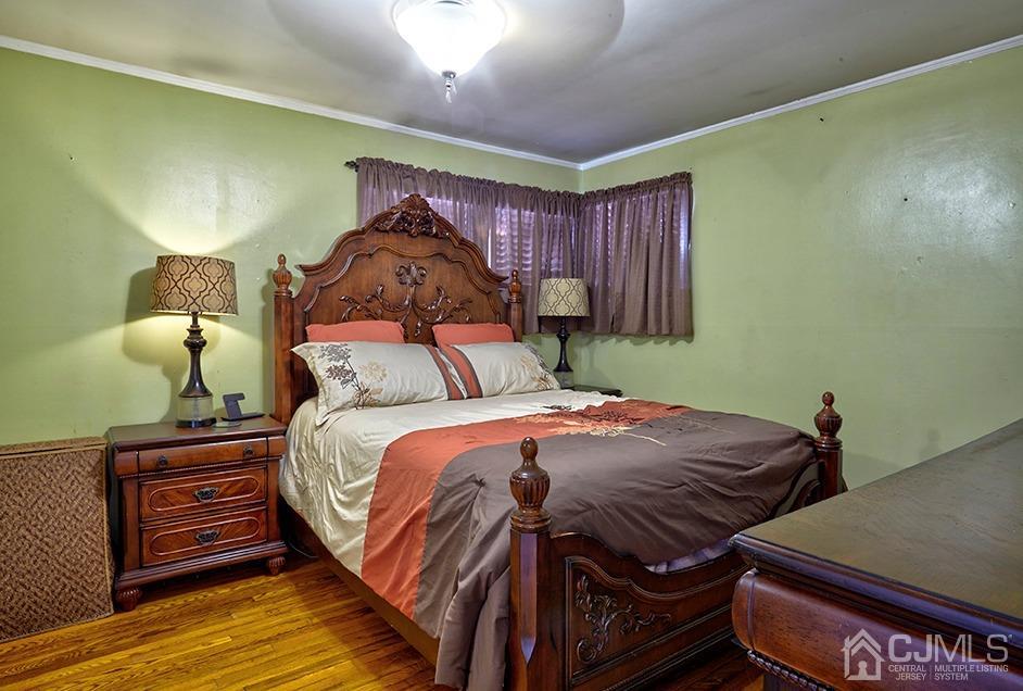10 Pennington Road New Brunswick, NJ 08901 - Photo 9 of 29 a bedroom with a bed and a painting on the wall