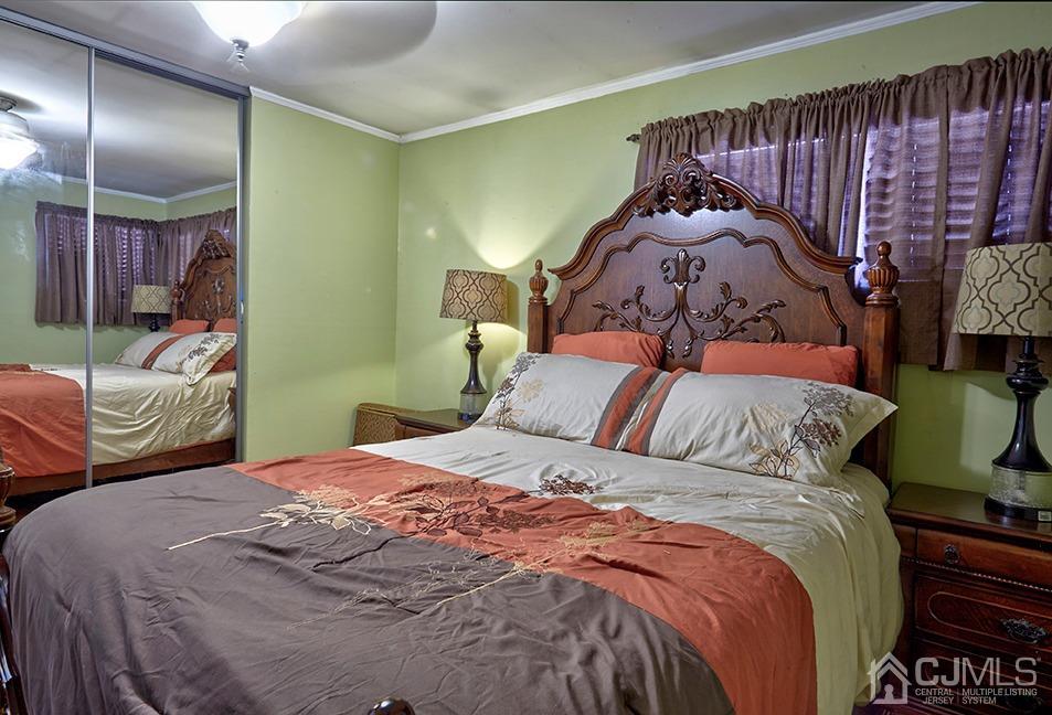 10 Pennington Road New Brunswick, NJ 08901 - Photo 10 of 29 a bedroom with a bed and a painting on the wall