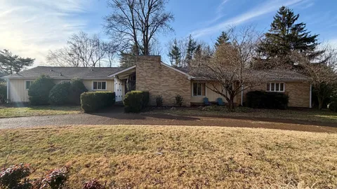 a view of a house with a yard covered with snow in front of house