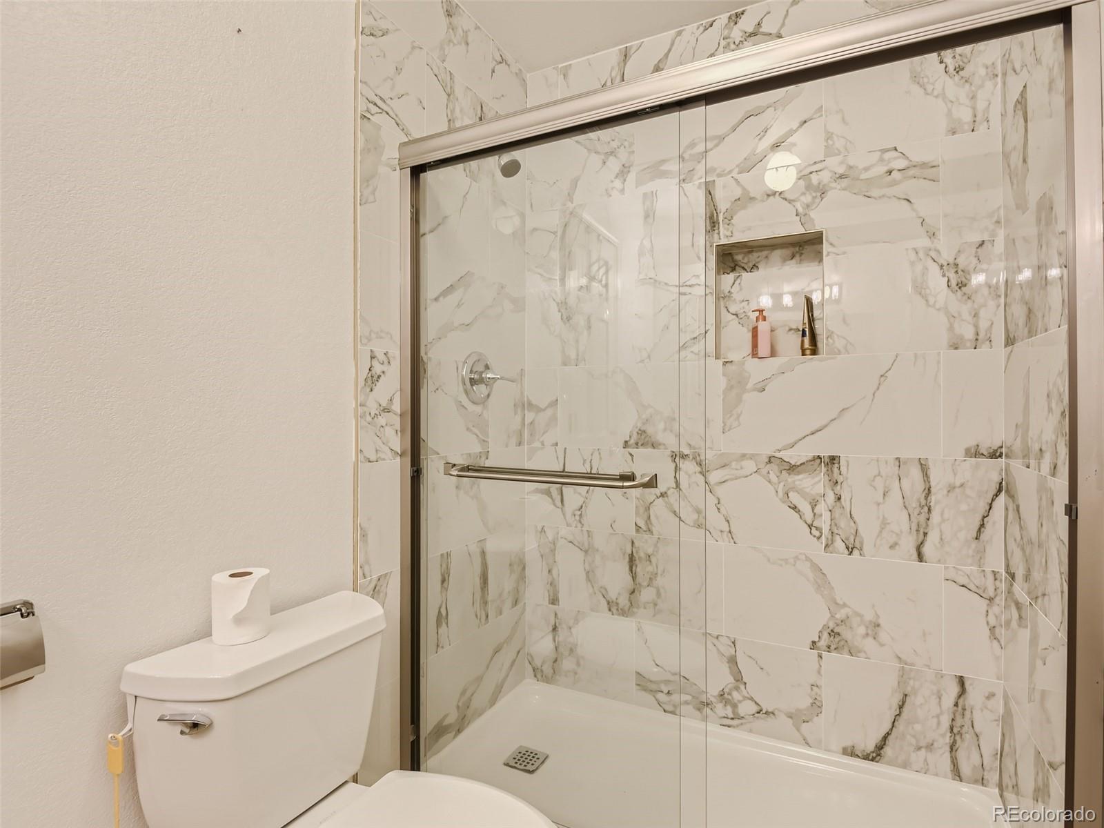 6722 Eagle Place Highlands Ranch, CO 80130 - Photo 12 of 34 a bathroom with a toilet and shower