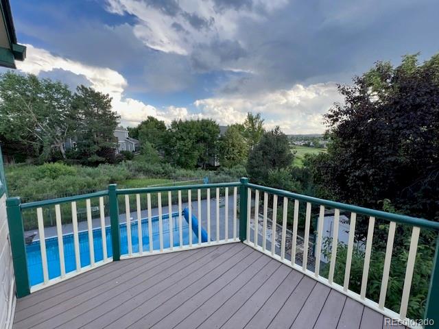 6722 Eagle Place Highlands Ranch, CO 80130 - Photo 15 of 34 a balcony with wooden floor and fence