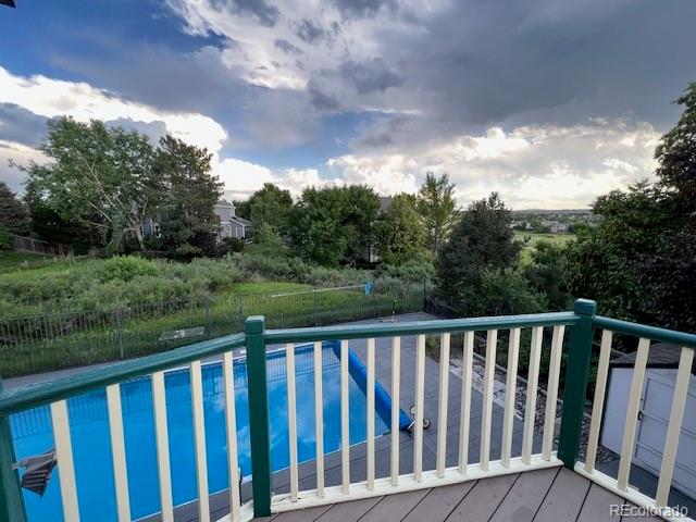 6722 Eagle Place Highlands Ranch, CO 80130 - Photo 17 of 34 a balcony with wooden floor and fence