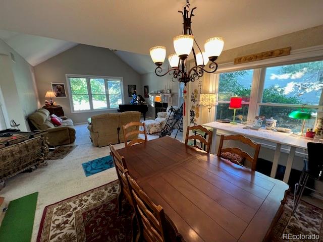 6722 Eagle Place Highlands Ranch, CO 80130 - Photo 20 of 34 a view of a dining room with furniture a chandelier and wooden floor