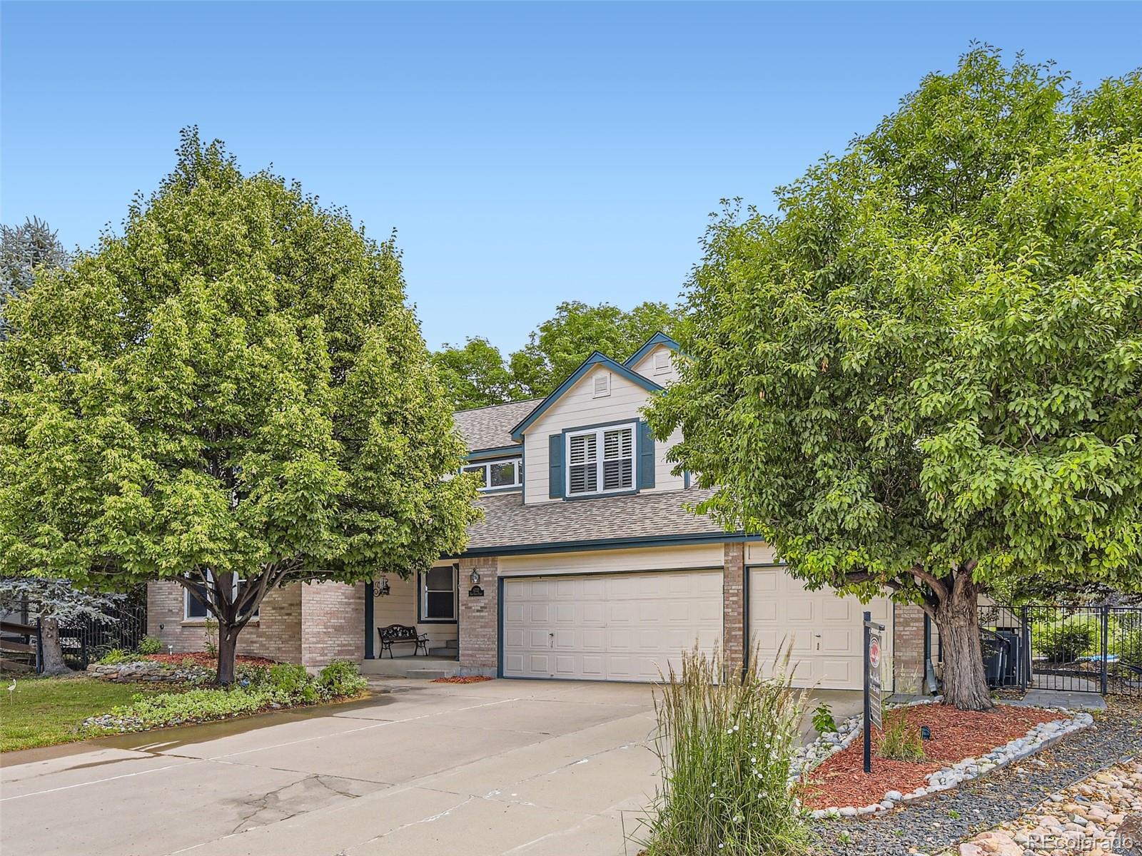 6722 Eagle Place Highlands Ranch, CO 80130 - Photo 2 of 34 a front view of a house with a garden