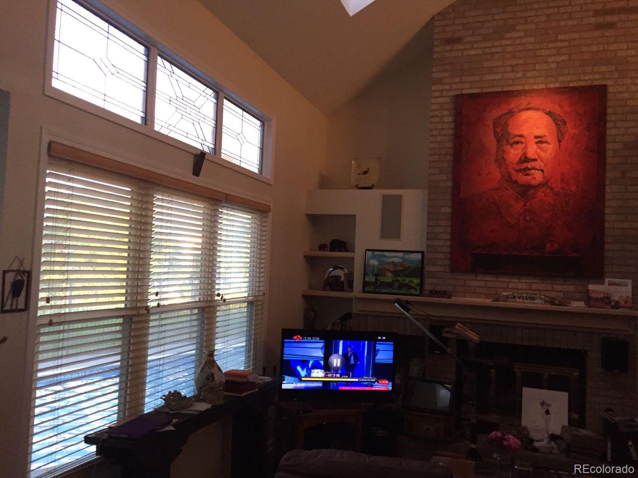 6722 Eagle Place Highlands Ranch, CO 80130 - Photo 25 of 34 a living room with fireplace furniture and a window